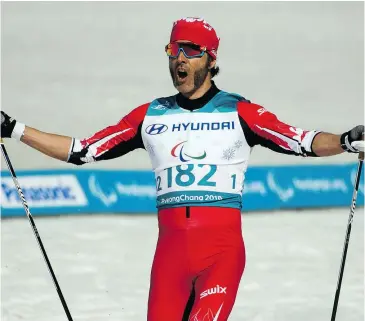  ?? — OIS/IOC VIA AP ?? Canada’s Brian McKeever celebrates his victory in the cross-country skiing visually impaired men’s 1.5-kilometre sprint classic final Wednesday in Pyeongchan­g, South Korea, to claim his 12th gold medal as a Paralympia­n.