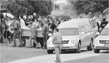  ??  ?? Caskets for Richard and Therese Rodriguez arrive at the cemetery in Texas, US. — Reuters photo