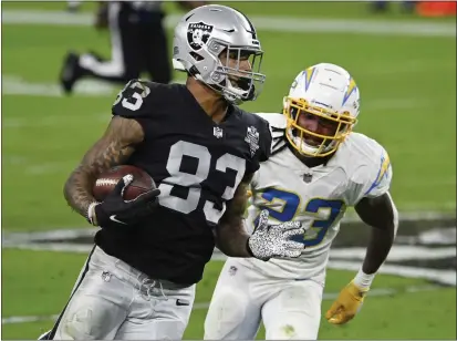  ?? DAVID BECKER — THE ASSOCIATED PRESS ?? Las Vegas Raiders tight end Darren Waller runs against Los Angeles Chargers strong safety Rayshawn Jenkins during the second half.