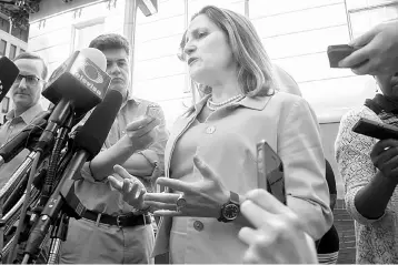  ?? — AFP photo ?? Freeland (centre) speaks prior to her meeting with US Trade Representa­tive Lighthizer in Washington, DC. With the deadline fast approachin­g, talks continued without reaching a deal between Canada and the US on an overhaul of the NAFTA.