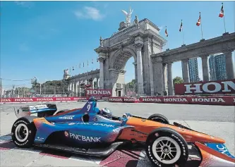  ?? FRANK GUNN THE CANADIAN PRESS ?? Scott Dixon passes in front of Princes' Gate during the first practice session for the Toronto Indy on Friday.