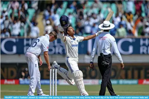  ?? — AFP ?? RAJKOT: India’s Yashasvi Jaiswal (C) celebrates after scoring a double century (200 runs) during the fourth day of the third Test cricket match between India and England at the Niranjan Shah Stadium in Rajkot.