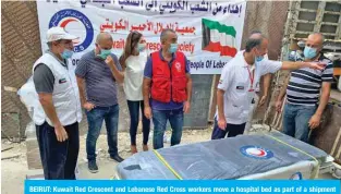  ??  ?? BEIRUT: Kuwait Red Crescent and Lebanese Red Cross workers move a hospital bed as part of a shipment of medical equipment donated by Kuwait to Lebanon’s hospitals. — KUNA photos