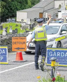  ?? PHOTO: DENIS BOYLE ?? Tragedy: Left: Michael Bowen. Above: A garda directs traffic at a checkpoint near the scene on the Kenmare Road close to Glengarrif­f, Co Cork.