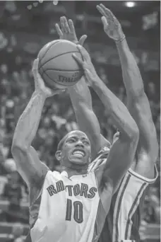  ?? DAVID COOPER/TORONTO STAR ?? Raptors DeMar DeRozan, left, fights to get to the rim under pressure from a Jazz defender during the second overtime period Monday night.