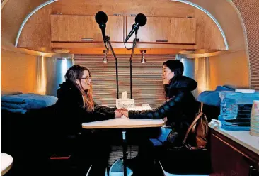  ?? [PHOTOS BY STEVE SISNEY, THE OKLAHOMAN] ?? Danielle Dodson and Brandi Guthery talk in the recording studio inside an AirStream trailer Thursday as staffers for StoryCorps record personal audio.