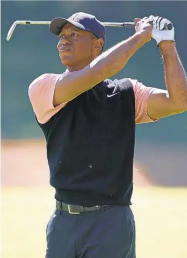  ?? AP ?? Tiger Woods watches his second shot on the seventh hole during the first round of the Genesis Invitation­al at Riviera Country Club on Thursday in the Pacific Palisades area of Los Angeles.