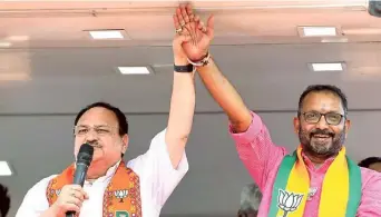  ?? ?? Strong front: BJP president J.P. Nadda and K. Surendran, the party’s Wayanad candidate for the Lok Sabha polls, at a roadshow in Wayanad on Friday.