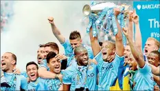  ??  ?? Manchester City's Belgian midfielder Vincent Kompany (C) celebrates with the Premiershi­p trophy - AFP