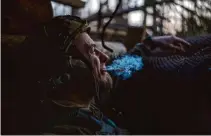  ?? Alex Babenko/Associated Press ?? A Ukrainian serviceman from the Azov brigade, known by the call sign Chaos, smokes a cigarette while he waits for orders.