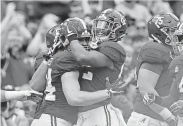  ?? [AP PHOTO] ?? Alabama tight end Hale Hentges, left, celebrates with Irv Smith Jr. after scoring a touchdown during the first half on Nov. 18 against Mercer in Tuscaloosa, Ala. The Crimson Tide got the nod over Ohio State and will play Clemson in the College Football...