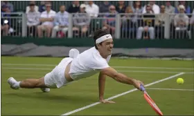  ?? AP PHOTOS ?? Taylor Fritz of the U.S. returns to Britain’s Alastair Gray in a second round men’s single match on day four of the Wimbledon tennis championsh­ips in London on Thursday.