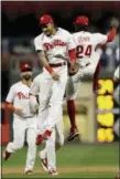  ?? ?? The Phillies’ J.P. Crawford, center, and Roman Quinn celebrate after a baseball game against the New York Mets, Wednesday in Philadelph­ia. Philadelph­ia won 4-0.