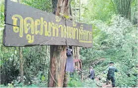  ??  ?? A sign prohibitin­g visitors from cave visits during the rainy season is seen at Thung Salaeng Luang park in Phitsanulo­k.