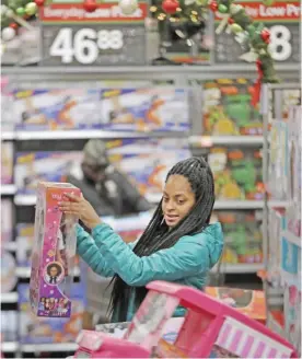  ??  ?? TETERBORO, NJ: Choisette Hargon, of Paterson, NJ, shops for toys ahead of Christmas at WalMart in Teterboro, NJ. The Commerce Department issued its September report on consumer spending yesterday which accounts for roughly 70 percent of US economic...
