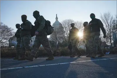  ?? TODD HEISLER / THE NEW YORK TIMES ?? Members of the National Guard patrol the perimeter of the Capitol Thursday in Washington. President Donald Trump’s efforts to overturn the 2020 presidenti­al election came to a dangerous head on Wednesday when a mob of his supporters stormed the U.S. Capitol following a rally in which Trump once again falsely claimed widespread voter fraud.