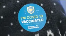  ?? THE CANADIAN PRESS ?? A woman wears a sticker to show she’s vaccinated at a clinic in Richmond. Vaccines can significan­tly reduce transmissi­on rates of COVID-19, regardless of whether Canada reaches herd immunity, an infectious disease expert says.