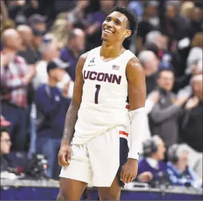  ?? Jessica Hill / Associated Press ?? UConn’s Christian Vital (1) smiles as the final seconds tick off in an upset of Houston earlier this month. Vital will be remembered as one the most popular players in recent memory.