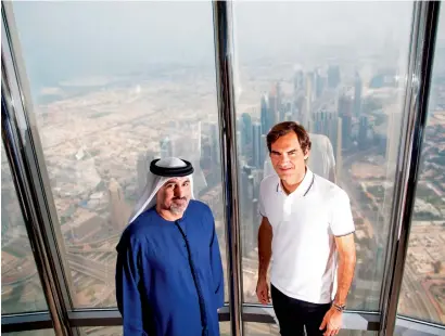  ?? Supplied photo ?? Roger Federer and Salah Tahlak enjoy the panoramic views of Dubai at The Lounge – atop the Burj Khalifa. —