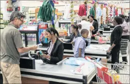  ?? PHOTO: BLOOMBERG ?? An employee processes a customer’s card payment at a checkout inside a Choppies supermarke­t in Rustenburg. Choppies plans to expand by almost 25 percent in Southern Africa.