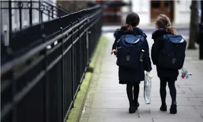  ?? Photograph: Hannah McKay/Reuters ?? ‘School closures can be an effective way to reduce the spread of a virus.’ Children leaving a school in London after it was closed by the coronaviru­s outbreak, March 2020.