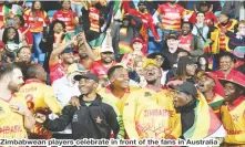  ?? ?? Zimbabwean players celebrate in front of the fans in Australia