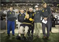  ?? PETER POWER, THE CANADIAN PRESS ?? Tiger-Cats 1957 and ’67 Grey Cup teams, considered two of the finest in history, were honoured Saturday night at Tim Hortons Stadium.