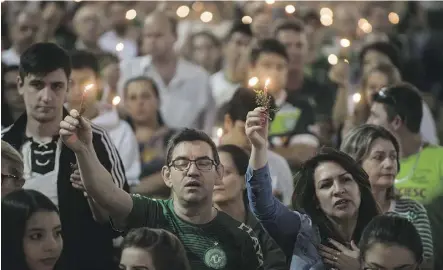  ?? NELSON ALMEIDA/AFP/GETTY IMAGES ?? Mourners attend a ceremony at Arena Conda in honour of the victims and survivors of LaMia flight 2933 on the first anniversar­y of the plane crash in Colombia.