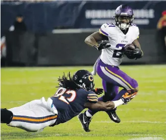 ?? REX ARBOGAST, THE ASSOCIATED PRESS ?? Vikings running back Jerick McKinnon avoids a tackle from Bears linebacker Pernell McPhee during the first half in Chicago on Monday.