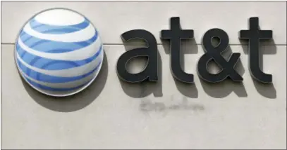  ?? STEVEN SENNE — THE ASSOCIATED PRESS FILE ?? This file photo shows an AT&T logo on a store in Dedham, Mass. On Saturday several reports citing unnamed sources said the giant phone company is in advanced talks to buy Time Warner, owner of the Warner Bros. movie studio as well as HBO and CNN. AT&T...