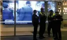  ?? Photograph: David Gray/ EPA ?? Police at the entrance to the ABC building in Sydney. Federal police raided the offices over a series of stories published in 2017, known as ‘The Afghan Files’, which suggested Australian troops may have committed war crimes.