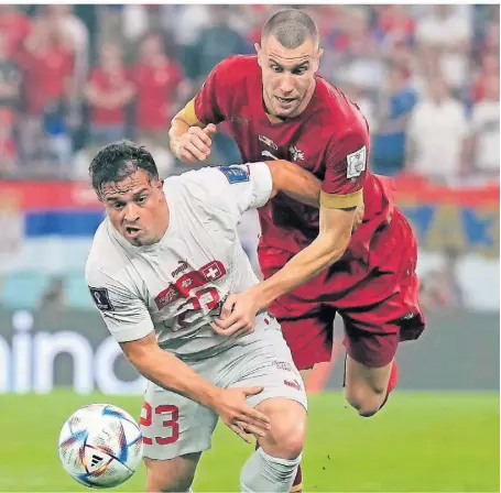  ?? FOTO: RICARDO MAZALAN/AP ?? Serbiens Strahinja Pavlovic (r.) und der Schweizer Xherdan Shaqiri in einem Zweikampf in einem der bislang packendste­n WM-Begegnunge­n in Katar.