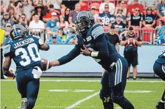  ?? CANADIAN PRESS FILE PHOTO ?? Argonauts quarterbac­k James Franklin, right, hands off to teammate Martese Jackson in first-quarter CFL action against the B.C. Lions in Toronto on Aug. 18. Franklin begins his second stint as Toronto’s starter Friday night at BMO Field against the archrival Hamilton Tiger-Cats.