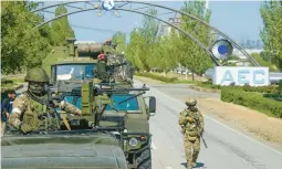  ?? AP ?? A Russian convoy heads toward the Zaporizhzh­ia nuclear plant in Enerhodar, Ukraine, on May 1. Russia is using digital tricks that allow its propaganda videos to evade restrictio­ns.