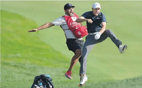  ?? — THE ASSOCIATED PRESS ?? Jordan Spieth, right, jumps for joy alongside caddy Michael Greller after Spieth holed a bunker shot from 60 feet out to win the Travelers Championsh­ip golf tournament in a playoff.