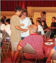  ?? JOHN BREWER — ONEIDA DAILY DISPATCH ?? Families and exchange students mingle as they celebrate the conclusion of the 2016Oneida CCI exchange program.