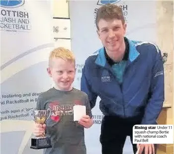  ??  ?? Rising star Under 11 squash champ Bertie with national coach Paul Bell
