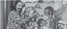  ??  ?? Left: Norval Morrisseau holds a paintbrush while standing in front of one of his paintings.
