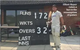  ??  ?? Elliott Mayer raises a bat to the resumption of games