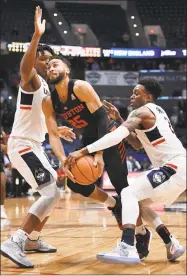  ?? Jessica Hill / Associated Press ?? UConn’s Tarin Smith, right, strips the ball from Houston's Galen Robinson Jr. (25) on Thursday.