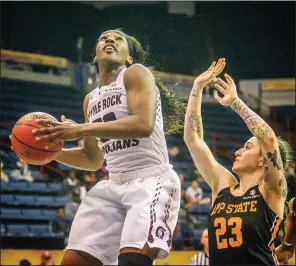  ?? Special to the Democrat-Gazette/EMILY KASK ?? UALR’s Raeyana DeGray (left) puts up a shot against Appalachia­n State’s Ashley Polacek during the Trojans’ 80-64 victory over the Mountainee­rs on Friday in the semifinals of the Sun Belt Conference Tournament at Lakefront Arena in New Orleans. DeGray finished with 17 points on 7-of-10 shooting from the floor.