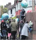  ??  ?? Shrine: Friends and relatives of Henry Vincent place tributes