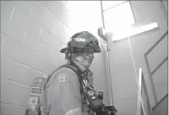  ?? Herald photo by Tim Kalinowski ?? Firefighte­r Mark Matheson donned his gear and climbed the stairs at Firehall 2 on Monday to raise awareness for the upcoming Lethbridge Memorial 911 Stair Climb at the Lethbridge Centre Tower on Sept. 9.