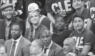  ?? JAMIE SABAU, GETTY IMAGES ?? Comedians Amy Schumer and Dave Chappelle attend Sunday’s NBA Eastern Conference final game in Cleveland.