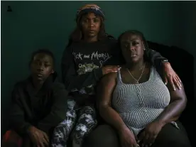  ?? Photograph: Ismail Ferdous/The Guardian ?? Dysheeka Atkins, right, with her son Elijah Junior, 13, and stepdaught­er Alexus, 25, in her apartment in New Jersey. Dysheeka’s partner, Elijah Sumler, died in prison two weeks before he was supposed to come home after serving 12 years.