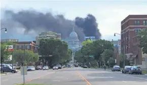  ?? KELLY TYRRELL OF MADISON ?? Black smoke fills the downtown Madison sky following an explosion and fire at Madison Gas and Electric's main power center and another fire at a substation.