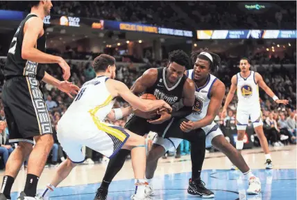  ?? STU BOYD II/THE COMMERCIAL APPEAL ?? Grizzlies forward Jaren Jackson Jr. secures a rebound from Warriors guard Klay Thompson (11) on Thursday at Fedexforum in Memphis.