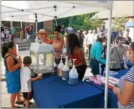  ??  ?? Children were treated to Sno-Kones and pizza Tuesday night during National Night Out in Kennett Square.