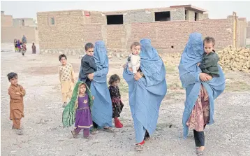  ?? AFP ?? Members of an internally displaced Afghan family in Enjil district of Herat on Thursday.