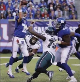  ?? FRANK FRANKLIN II — THE ASSOCIATED PRESS ?? New York Giants quarterbac­k Eli Manning (10) throws under pressure from Philadelph­ia Eagles defensive end Brandon Graham (55) and defensive end Vinny Curry (75) during the third quarter of an NFL football game, Sunday, Nov. 6, 2016, in East Rutherford, N.J.